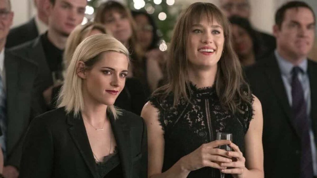 Kristen Stewart revela assistir The Crown para se preparar para viver Lady Di em filme Kristen Stewart e Mackenzie Davis em Happiest Season ( Reprodução / Hulu)