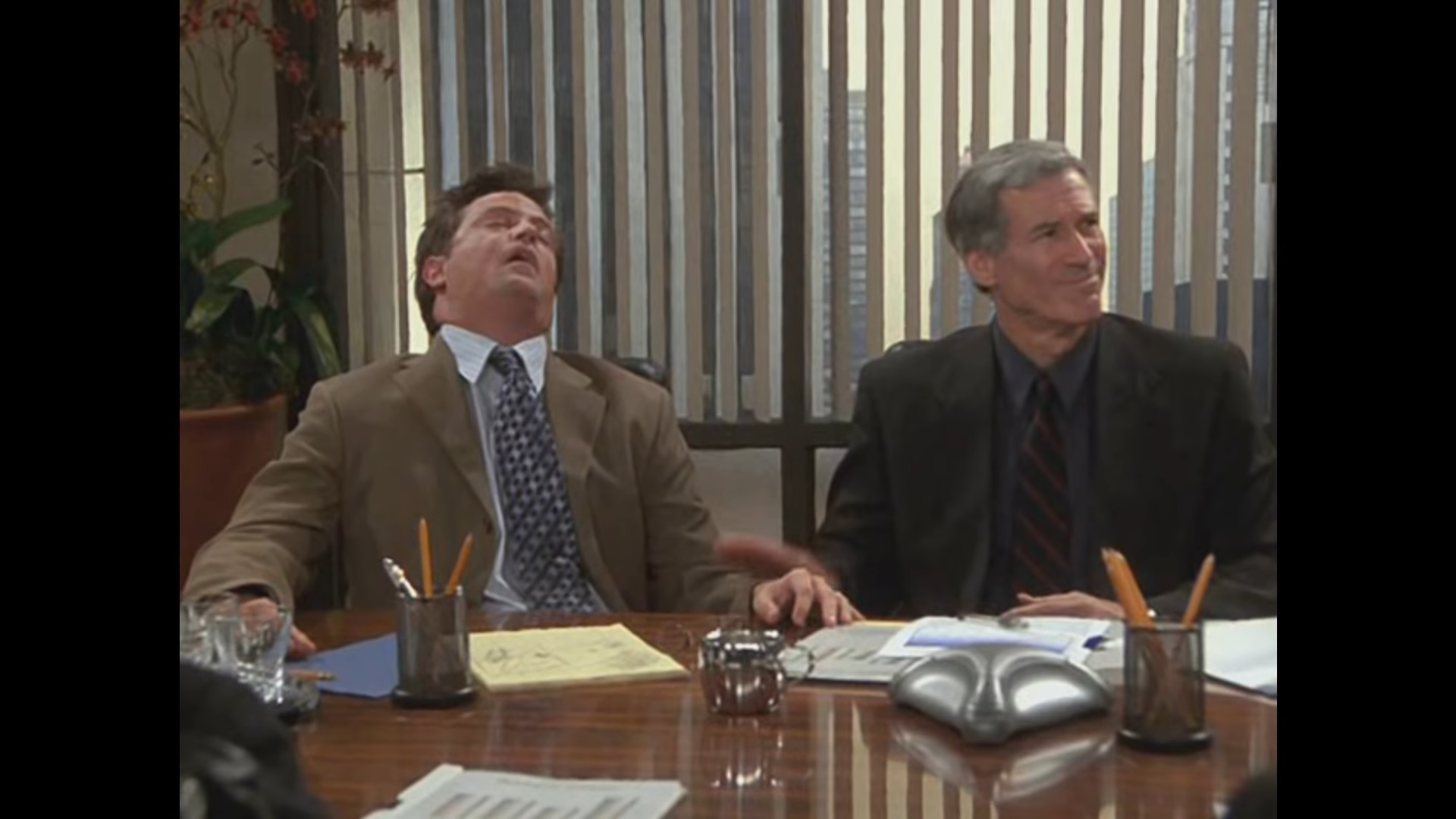 Chandler sleeps in the middle of a work meeting as his boss talks about him going to Tulsa 