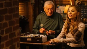 Entrando Na Maior Fria ganha trailer com Ariana Grande e data de estreia confirmada Ariana Grande e Robert De Niro em cena de Entrando na Maior Fria, em ambiente interno com bancada de ferramentas e clima descontraído