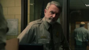 Após vencer câncer, astro de Jurassic Park celebra recuperação Sam Neil em cena de Indomável, produção da Netflix.