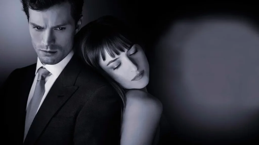 Christian Grey e Anastacia em arte promocional de 50 tons de cinza