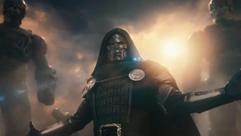 Doutor Destino aparece em destaque em cena de Vingadores: Doutor Destino diante de robôs em meio a um cenário de batalha.